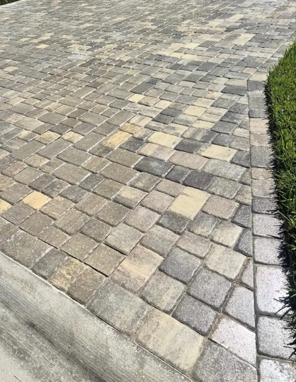 Clean interlocking paver driveway after pressure washing