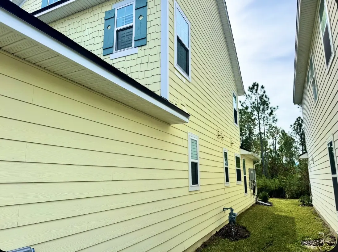 Clean yellow house siding after a soft wash